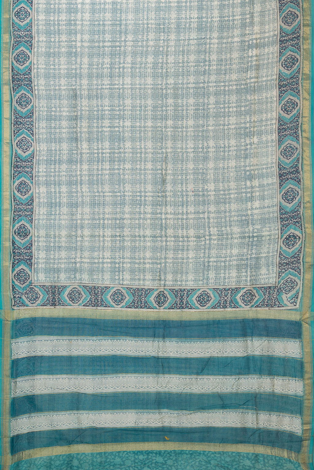 Flat view of Grey Dual Tone Chanderi Silk Saree with Printed design on the body and Zari Border. 