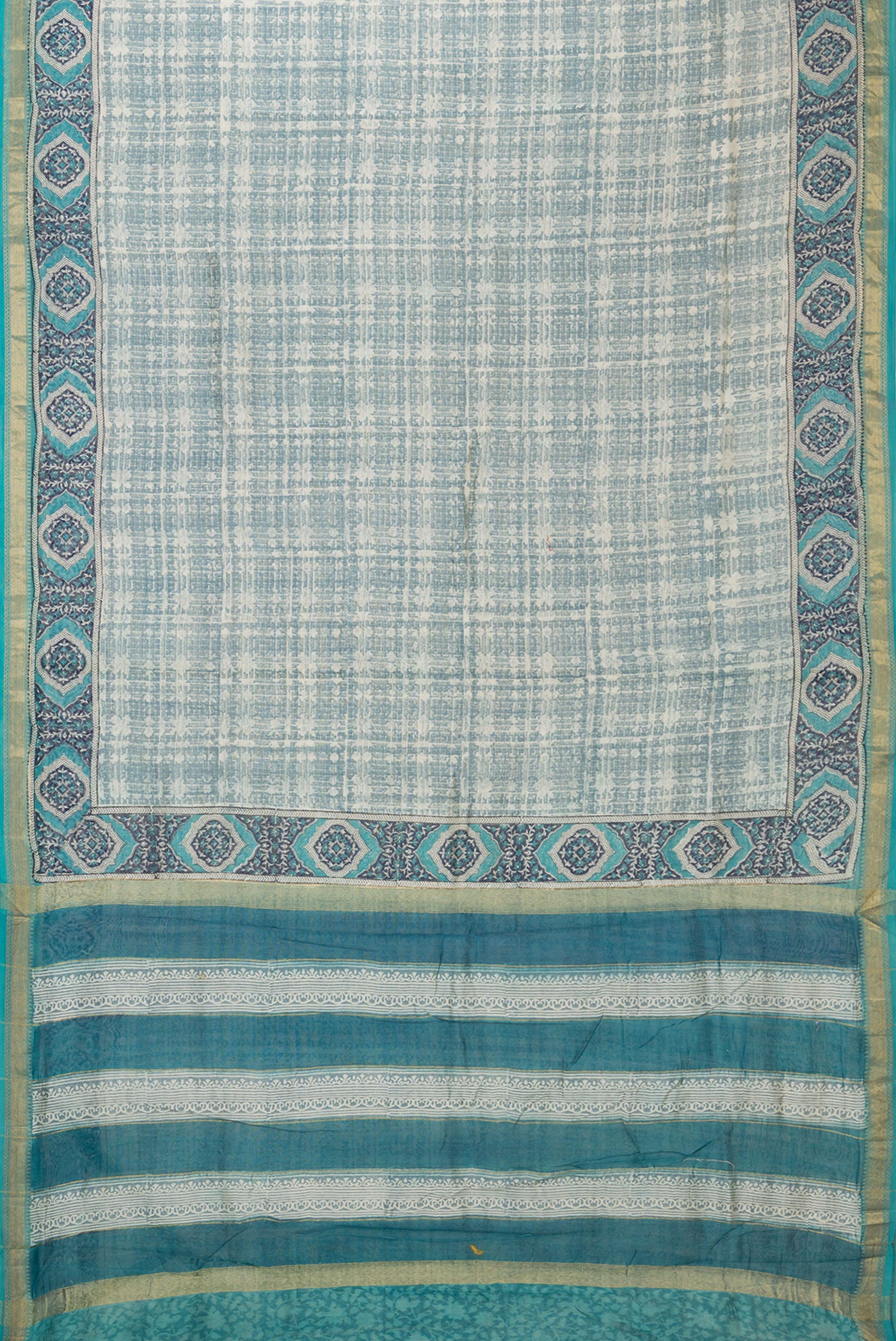 Flat view of Grey Dual Tone Chanderi Silk Saree with Printed design on the body and Zari Border. 