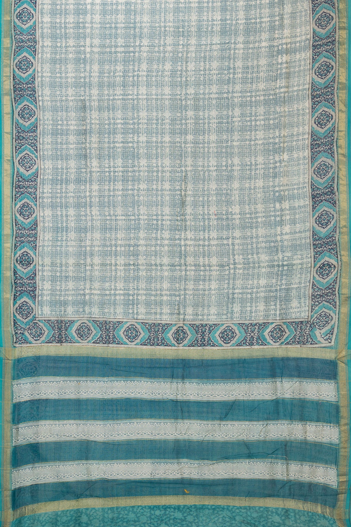 Flat view of Grey Dual Tone Chanderi Silk Saree with Printed design on the body and Zari Border. 