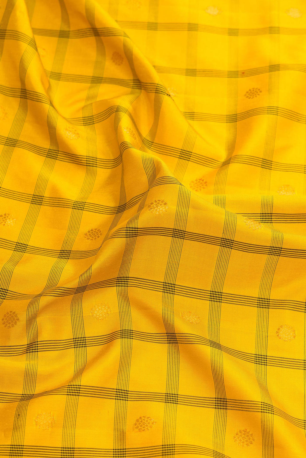Close up of Yellow Dual Tone Gadwal Silk Saree with Checked design on the body and Temple Border.  displaying folds