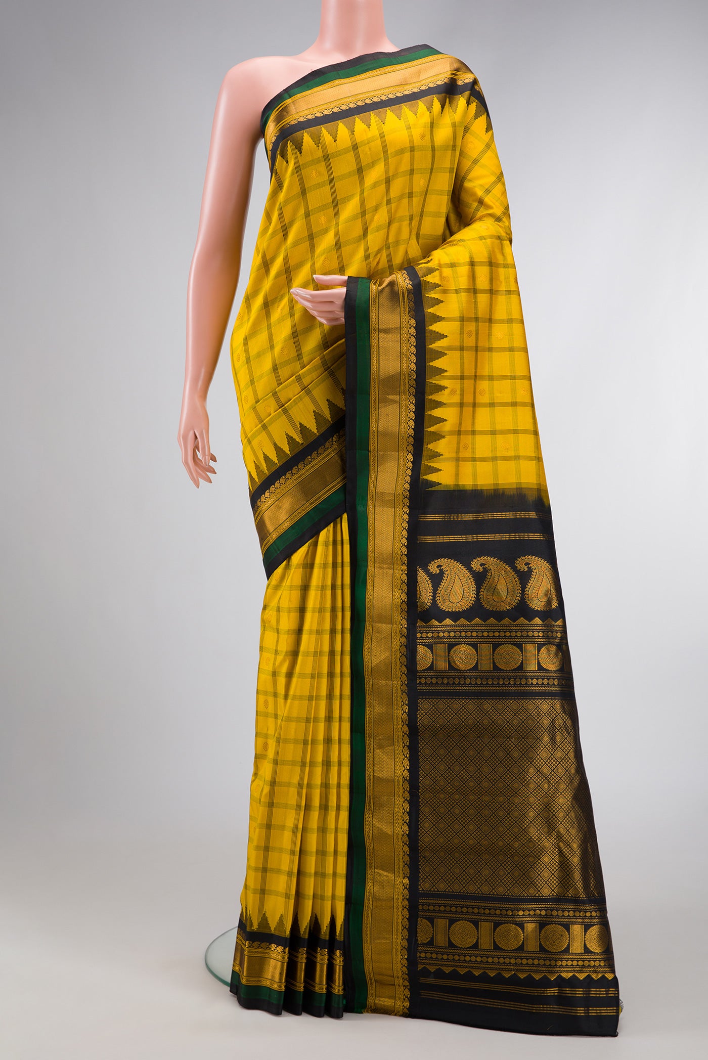 Yellow Dual Tone Gadwal Silk Saree with Checked design on the body and Temple Border.  displayed on a mannequin
