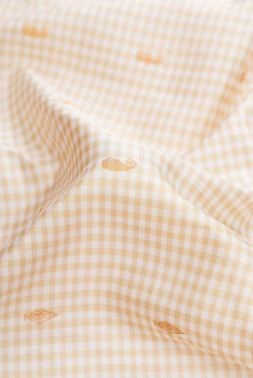 Close up of Off White Dual Tone Gadwal Silk Saree with Zari Butta on the body and Zari Border.  displaying folds