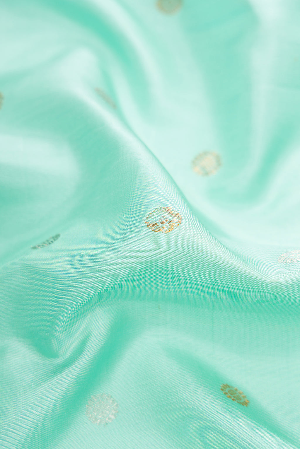 Close up of Sky Blue Dual Tone Gadwal Silk Saree with Zari Butta on the body and Zari Border.  displaying folds