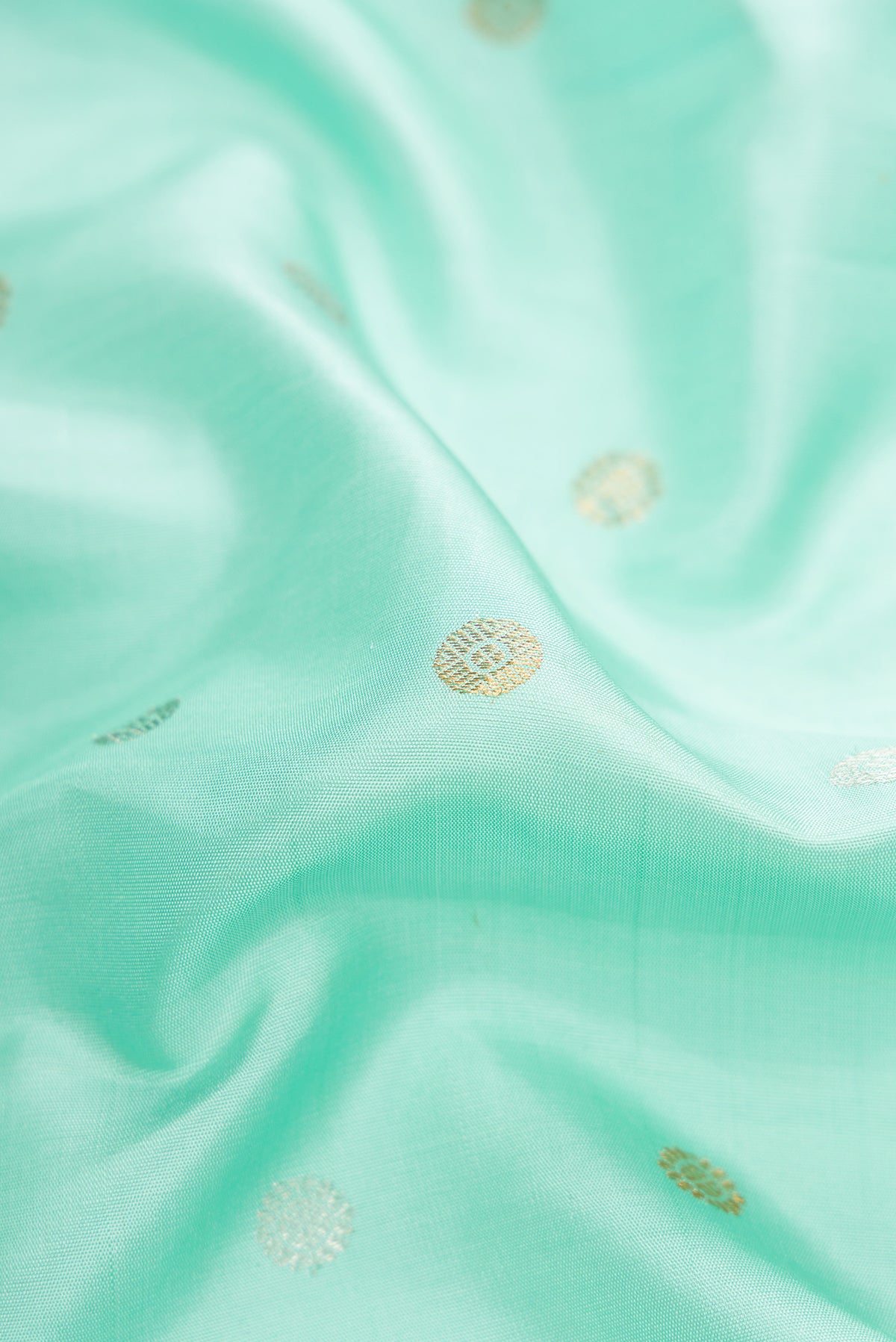 Close up of Sky Blue Dual Tone Gadwal Silk Saree with Zari Butta on the body and Zari Border.  displaying folds