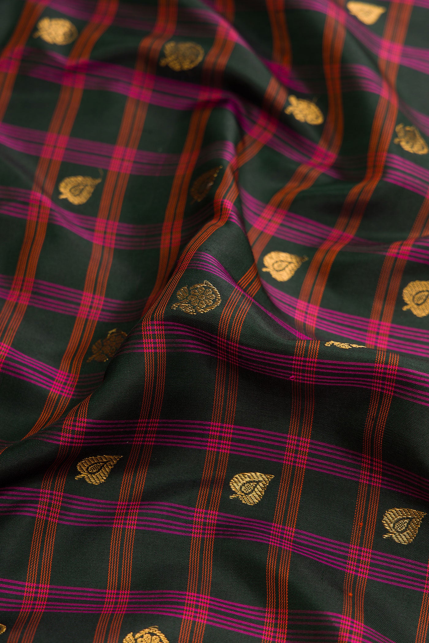 Close up of Black Dual Tone Gadwal Silk Saree with Checked design on the body and Zari Border.  displaying folds