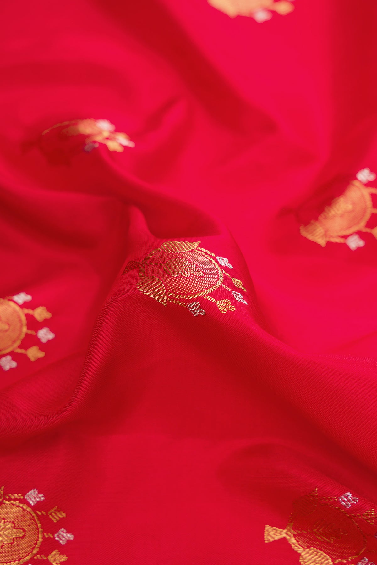 Close up of Pure Silk Pure Zari Red Dual Tone Gadwal Saree with Zari Butta on the body and Zari Border.  displaying folds