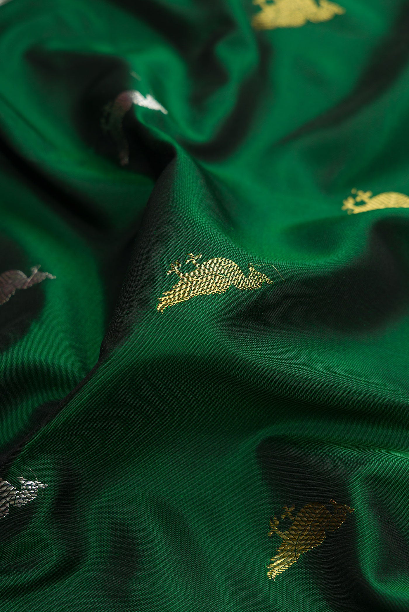 Close up of Green Dual Tone Gadwal Silk Saree with Zari Butta on the body and Zari Border.  displaying folds