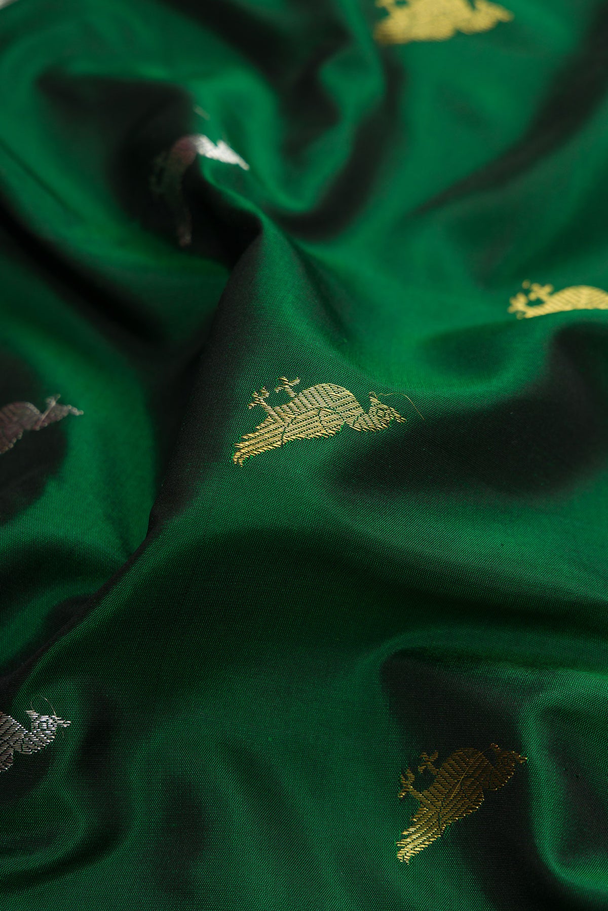 Close up of Green Dual Tone Gadwal Silk Saree with Zari Butta on the body and Zari Border.  displaying folds