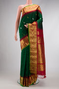 Green Dual Tone Gadwal Silk Saree with Zari Butta on the body and Zari Border.  displayed on a mannequin