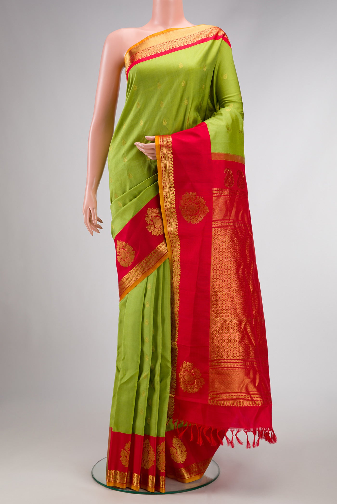 Parrot Green Dual Tone Gadwal Silk Saree with Zari Butta on the body and Zari Border.  displayed on a mannequin