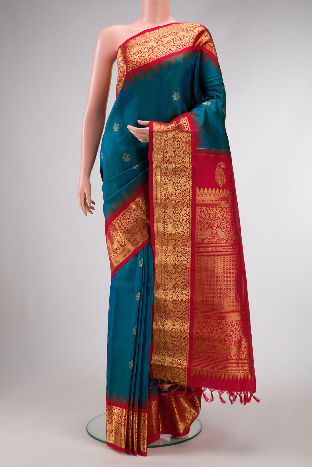 Peacock Blue Dual Tone Gadwal Silk Saree with Zari Butta on the body and Zari Border.  displayed on a mannequin