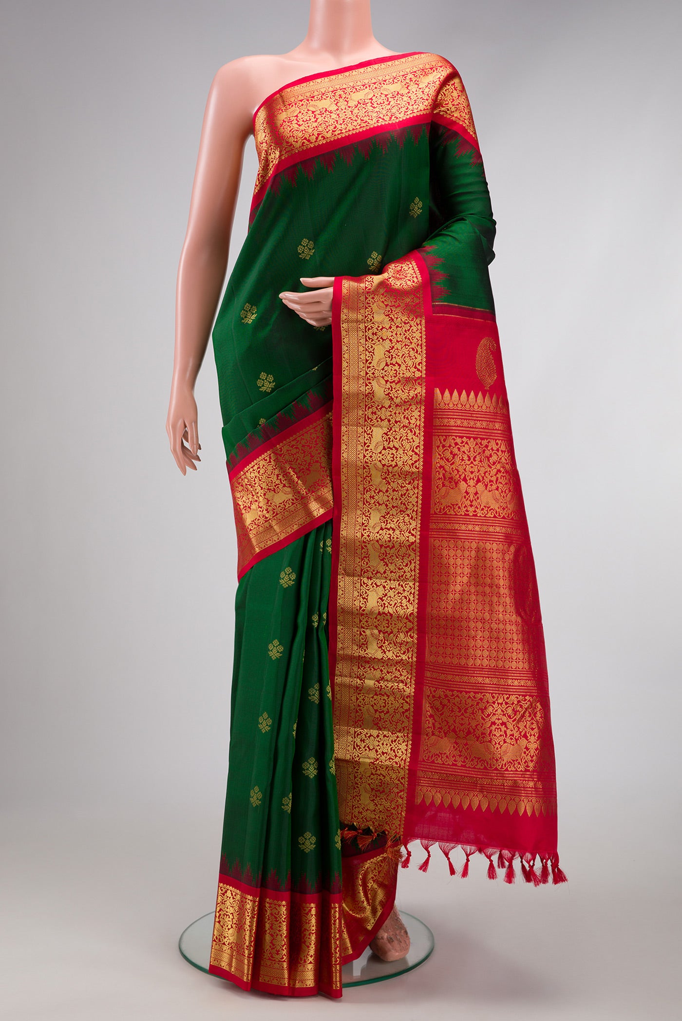 Bottle Green Gadwal Silk Saree with Zari Butta on the body and Zari Border.  displayed on a mannequin