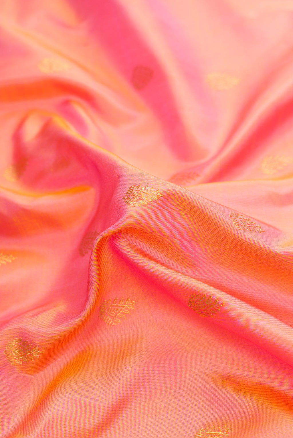 Close up of Golden Peach Dual Tone Gadwal Silk Saree with Zari Butta on the body and Fancy Border.  displaying folds