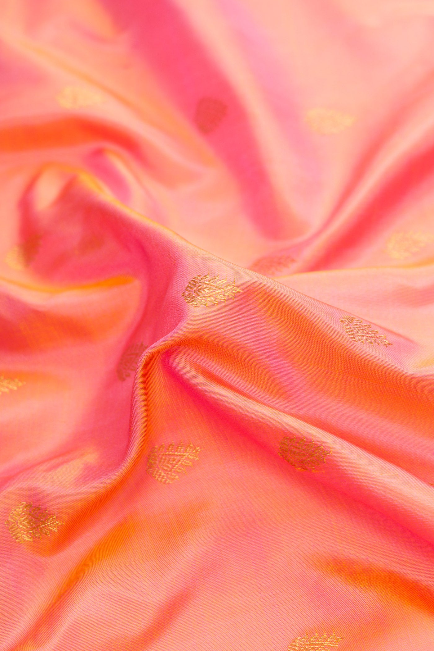 Close up of Golden Peach Dual Tone Gadwal Silk Saree with Zari Butta on the body and Fancy Border.  displaying folds