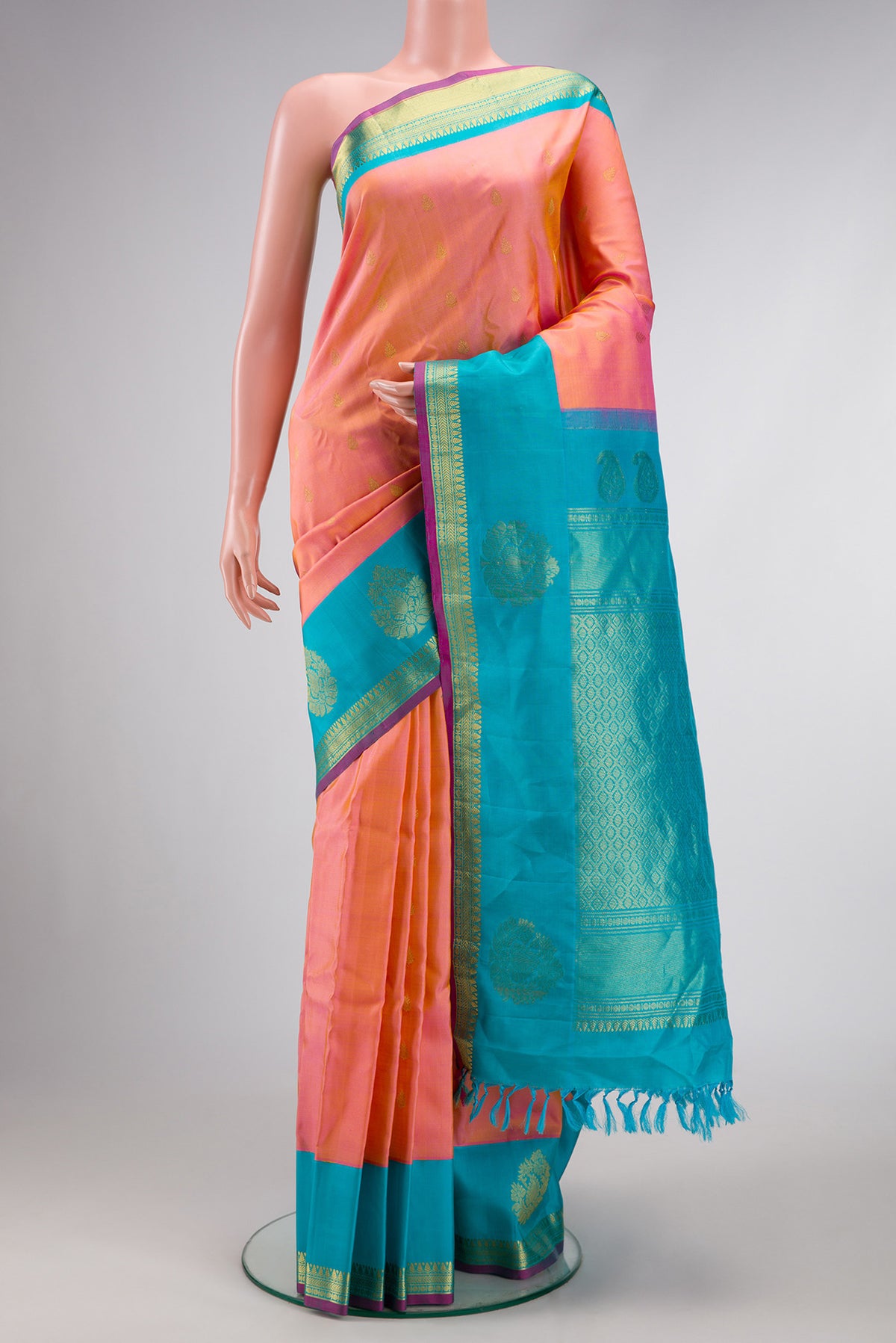 Golden Peach Dual Tone Gadwal Silk Saree with Zari Butta on the body and Fancy Border.  displayed on a mannequin
