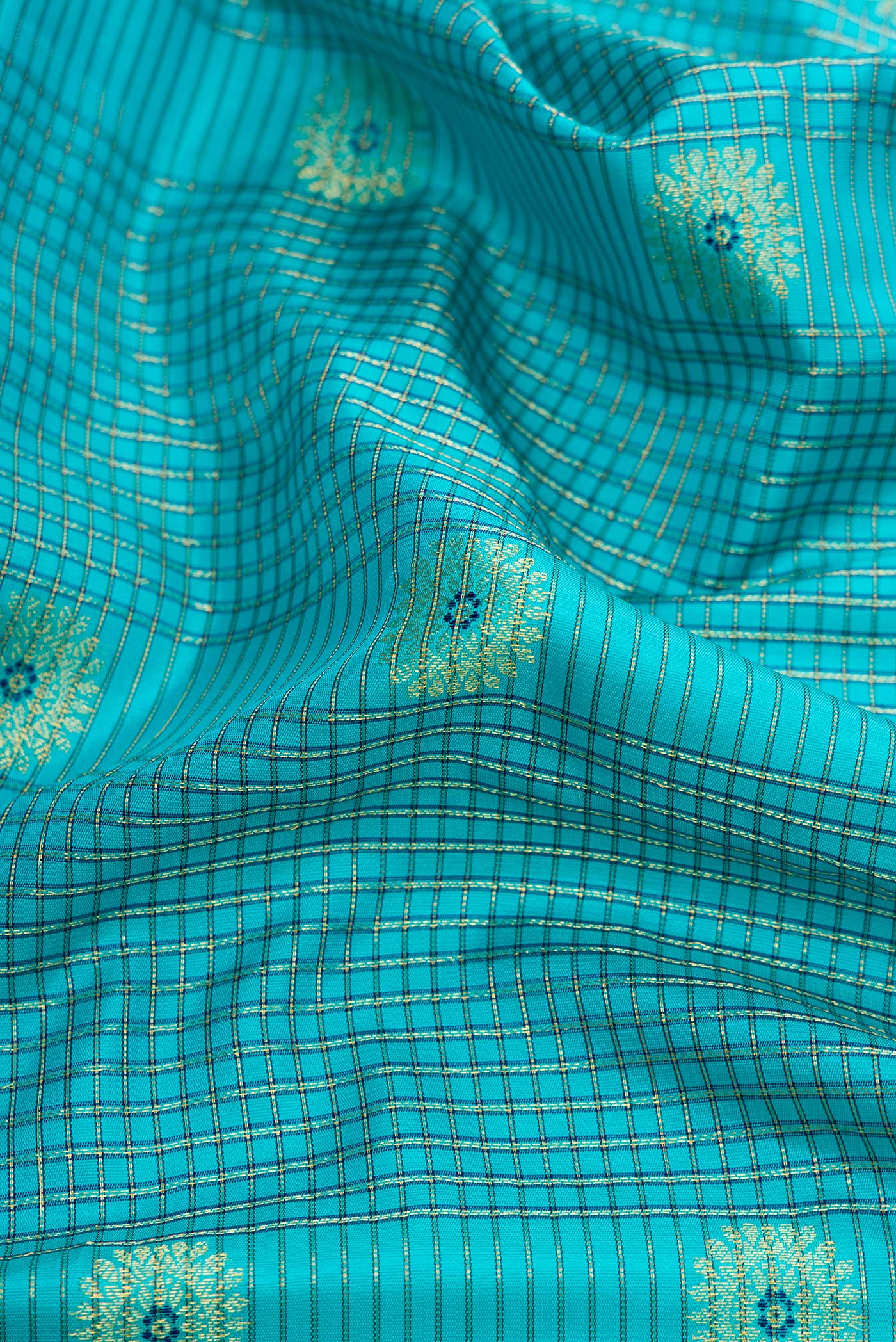 Close up of Sky Blue Dual Tone Gadwal Silk Saree with Checked design on the body and Temple Border.  displaying folds