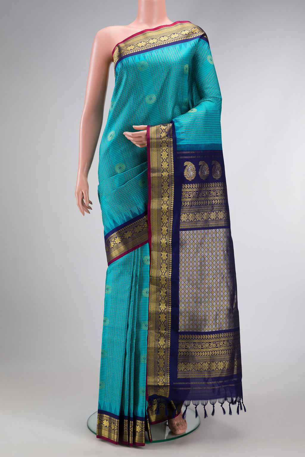 Sky Blue Dual Tone Gadwal Silk Saree with Checked design on the body and Temple Border.  displayed on a mannequin