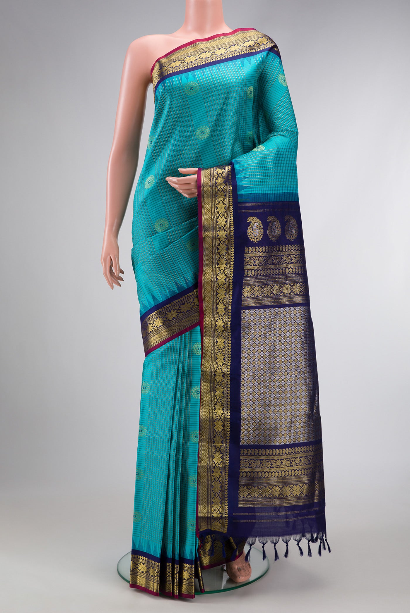 Sky Blue Dual Tone Gadwal Silk Saree with Checked design on the body and Temple Border.  displayed on a mannequin