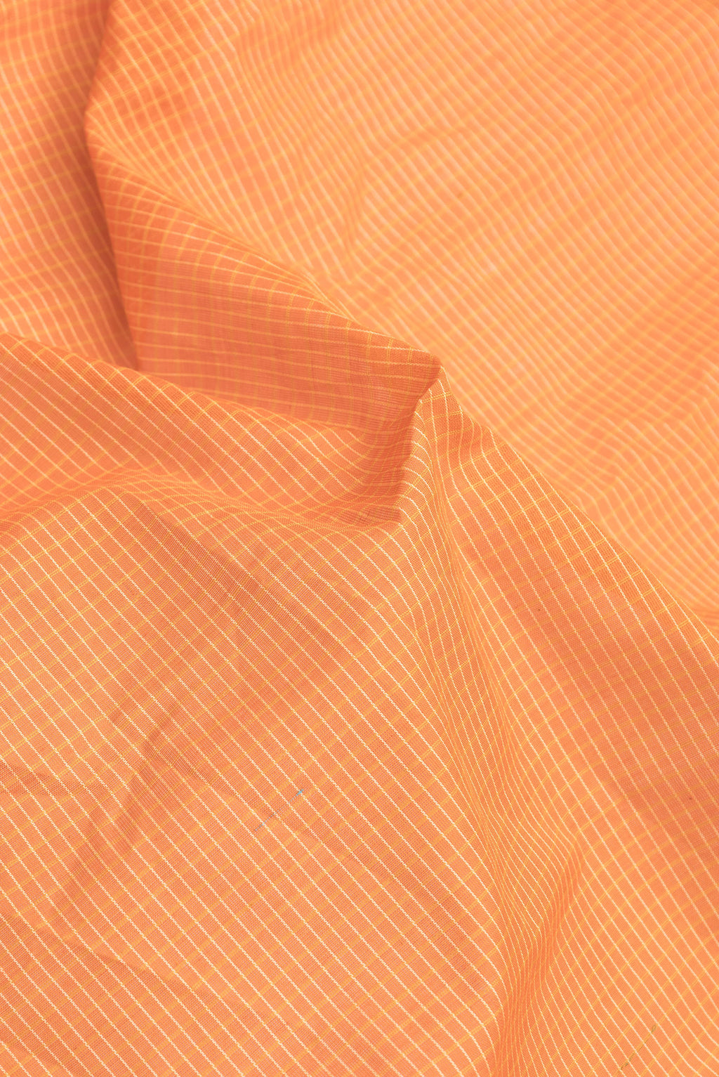 Close up of Orange Dual Tone Gadwal Silk Saree with Checked design on the body and Zari Border.  displaying folds