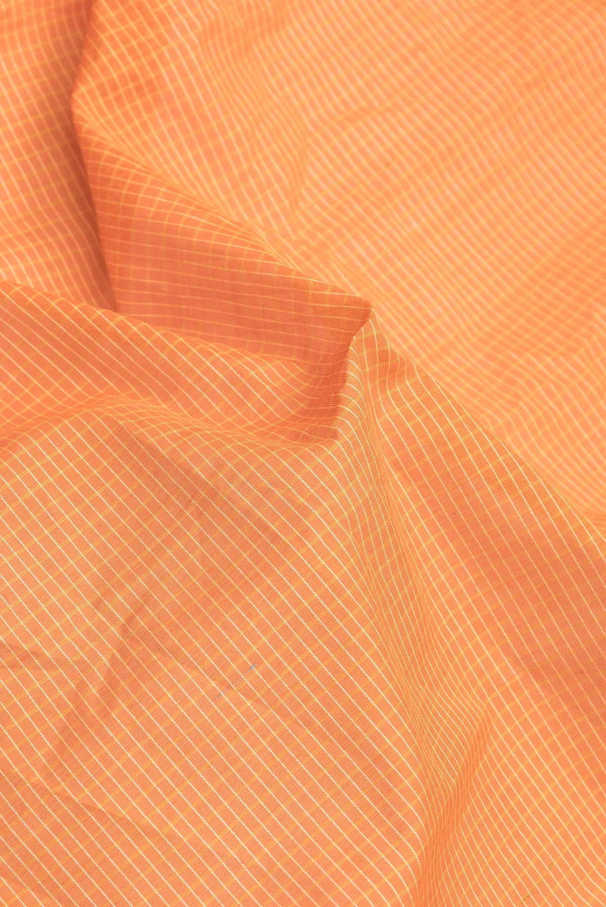 Close up of Orange Dual Tone Gadwal Silk Saree with Checked design on the body and Zari Border.  displaying folds