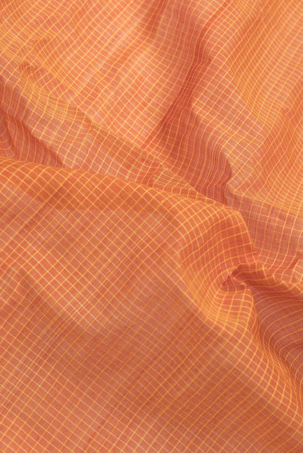 Close up of Orange Dual Tone Gadwal Silk Saree with Checked design on the body and Zari Border.  displaying folds