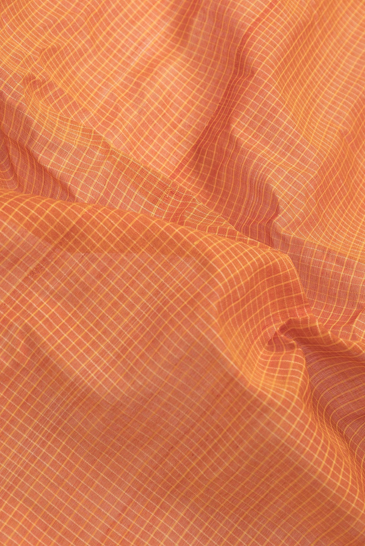 Close up of Orange Dual Tone Gadwal Silk Saree with Checked design on the body and Zari Border.  displaying folds