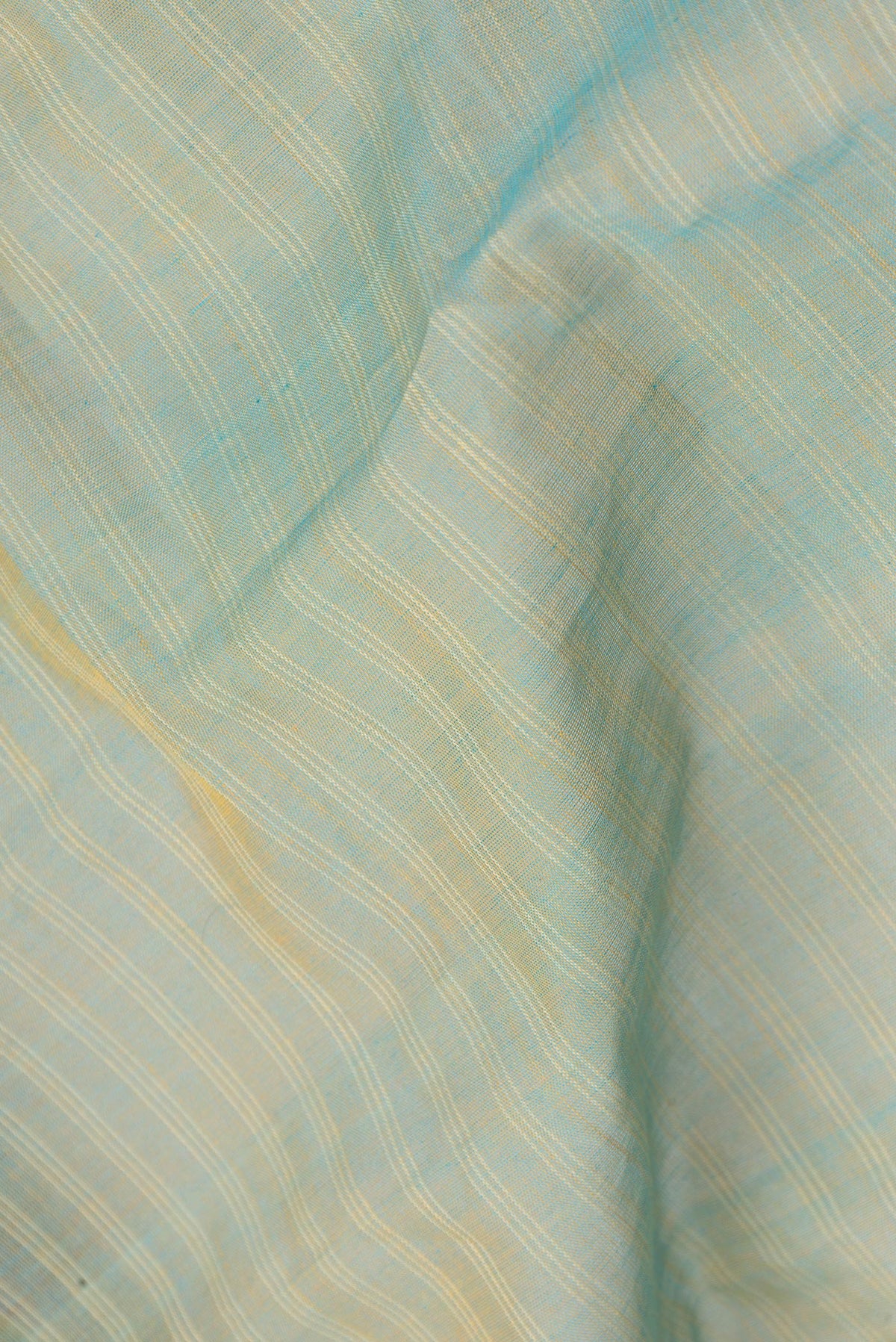 Close up of Pista Green Dual Tone Gadwal cotton Saree with Stripes on the body and Zari Border.  displaying folds