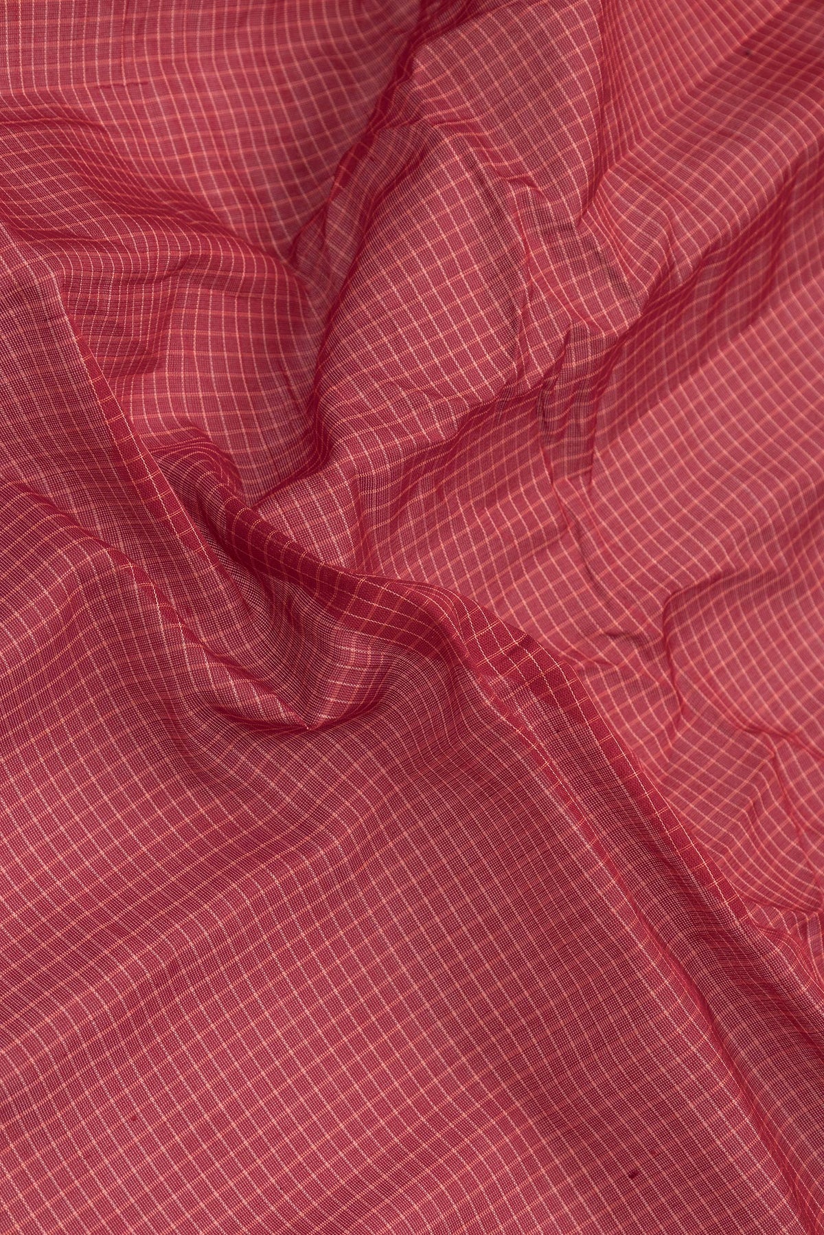 Close up of Maroon Dual Tone Gadwal cotton Saree with Checked design on the body and Zari Border.  displaying folds