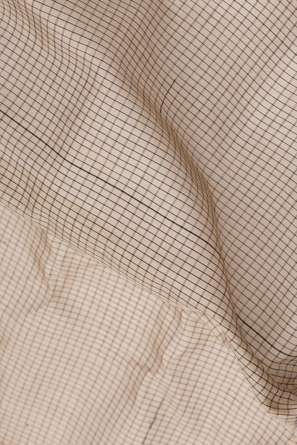 Close up of Beige Dual Tone Gadwal Silk Cotton Saree with Checked design on the body and Zari Border.  displaying folds