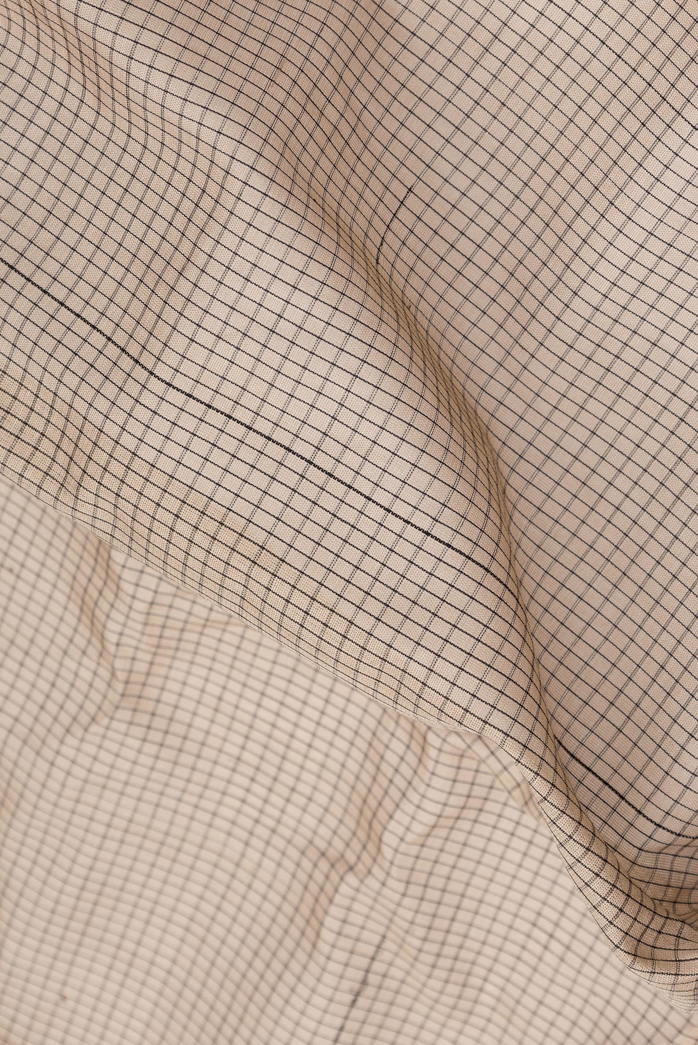 Close up of Beige Dual Tone Gadwal Silk Cotton Saree with Checked design on the body and Zari Border.  displaying folds