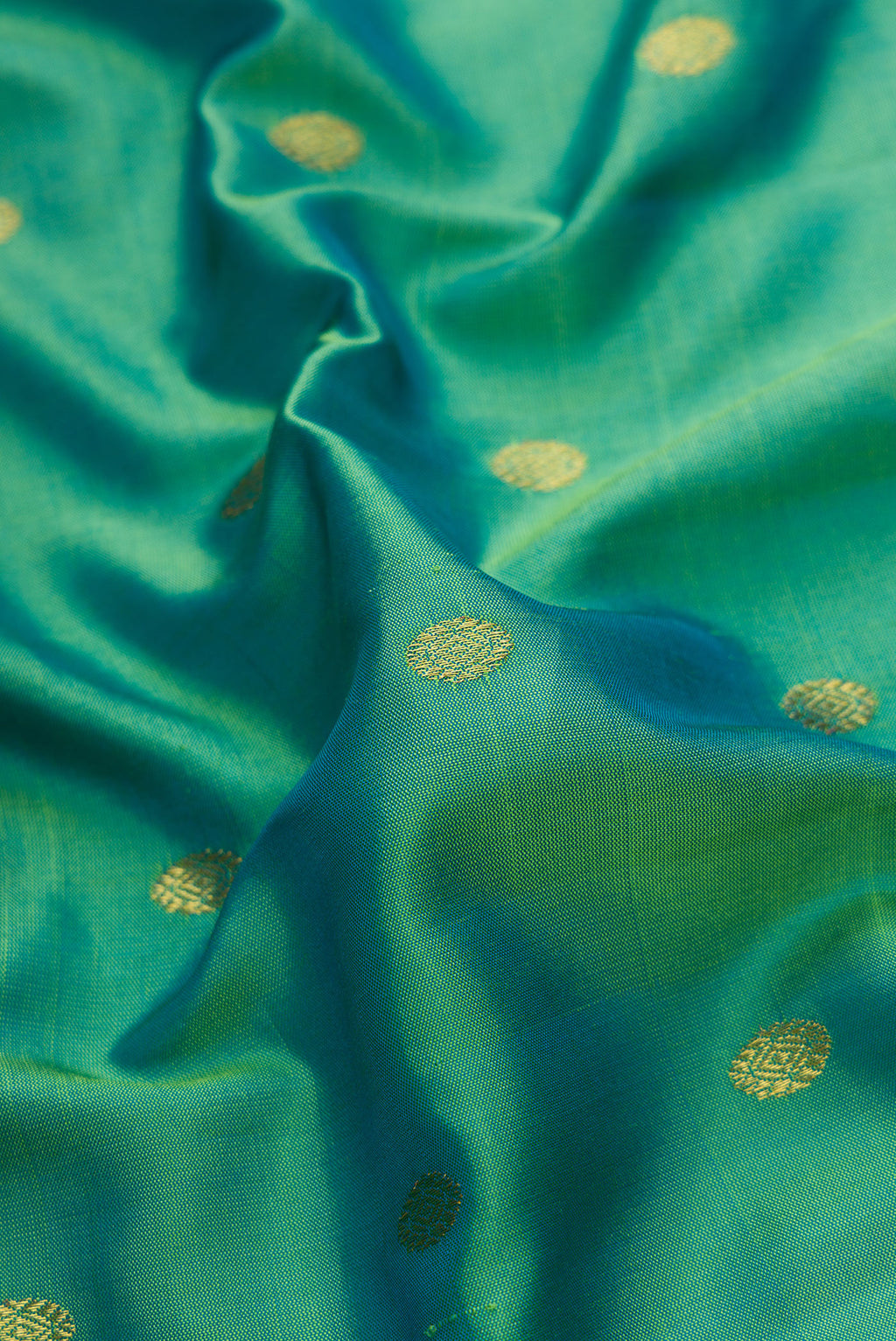 Close up of Green Dual Tone Gadwal Silk Saree with Zari Butta on the body and Zari Border.  displaying folds