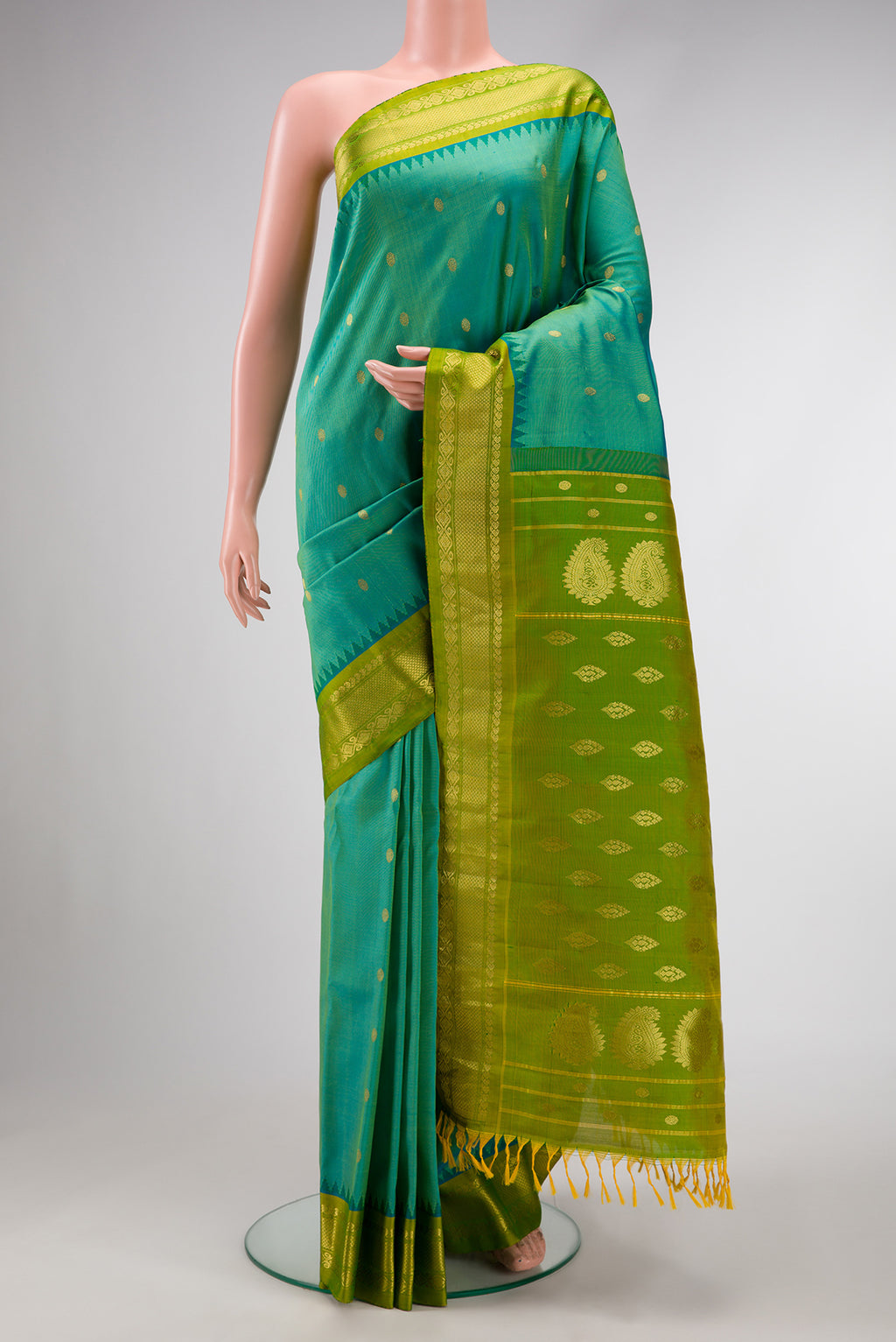 Green Dual Tone Gadwal Silk Saree with Zari Butta on the body and Zari Border.  displayed on a mannequin