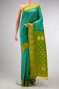 Green Dual Tone Gadwal Silk Saree with Zari Butta on the body and Zari Border.  displayed on a mannequin