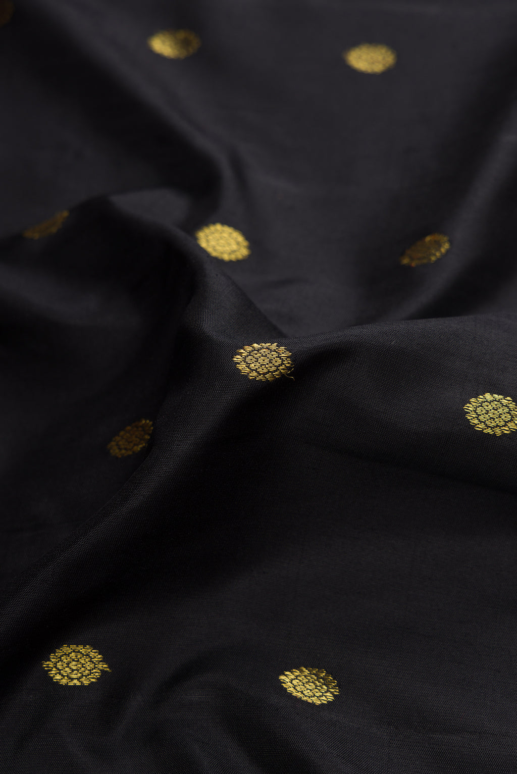 Close up of Black Dual Tone Gadwal Silk Saree with Zari Butta on the body and Zari Border.  displaying folds