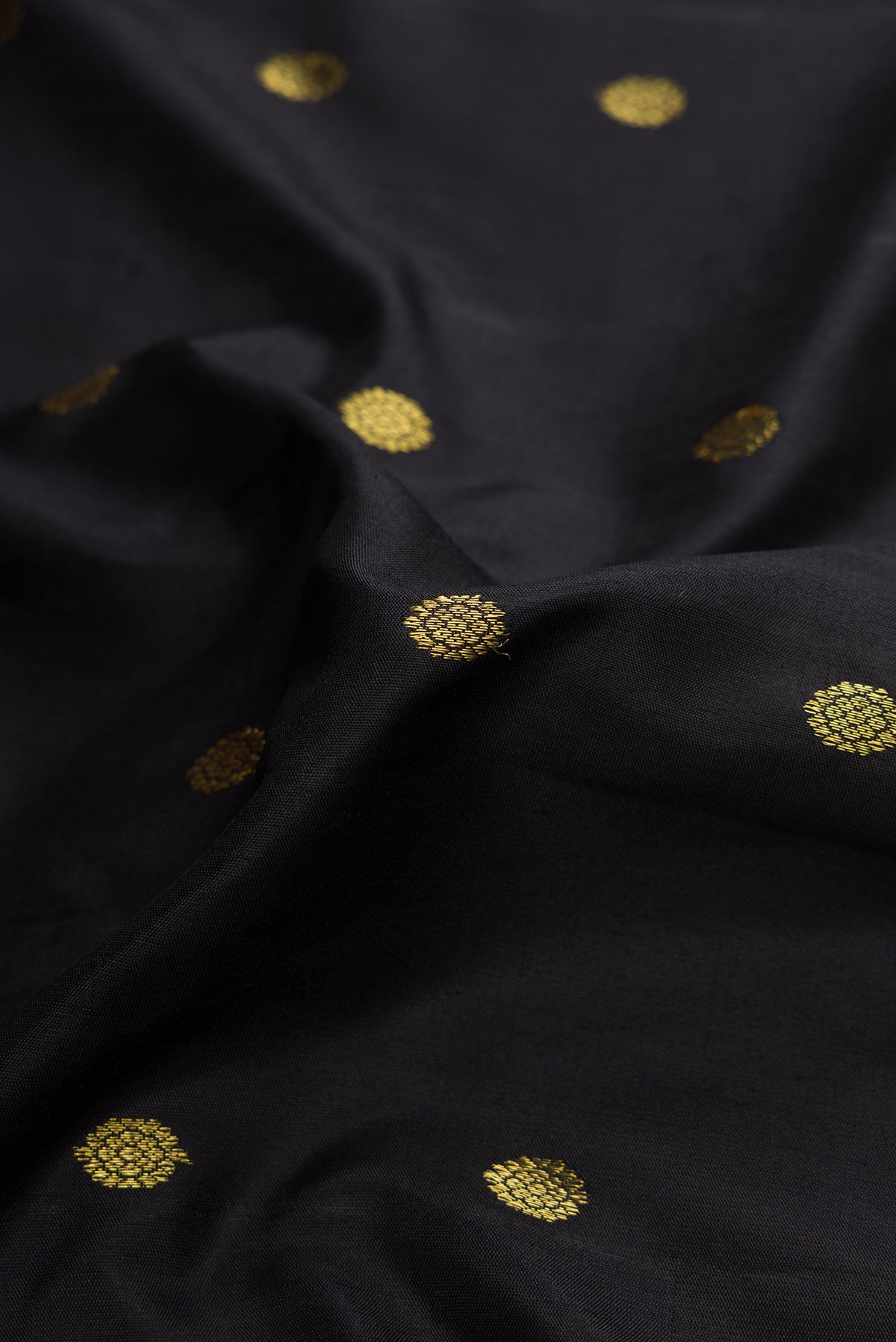 Close up of Black Dual Tone Gadwal Silk Saree with Zari Butta on the body and Zari Border.  displaying folds