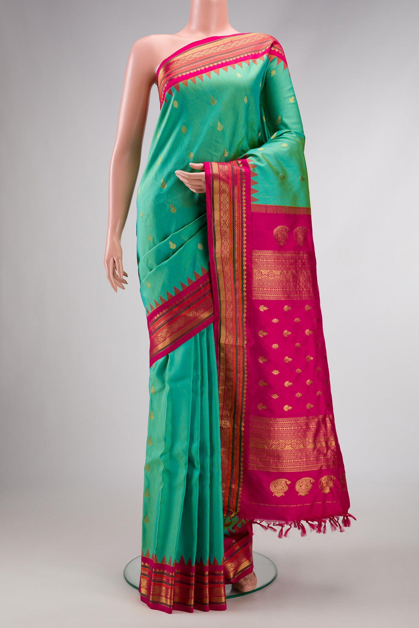 Light Green Dual Tone Gadwal Silk Saree with Zari Butta on the body and Zari Border.  displayed on a mannequin