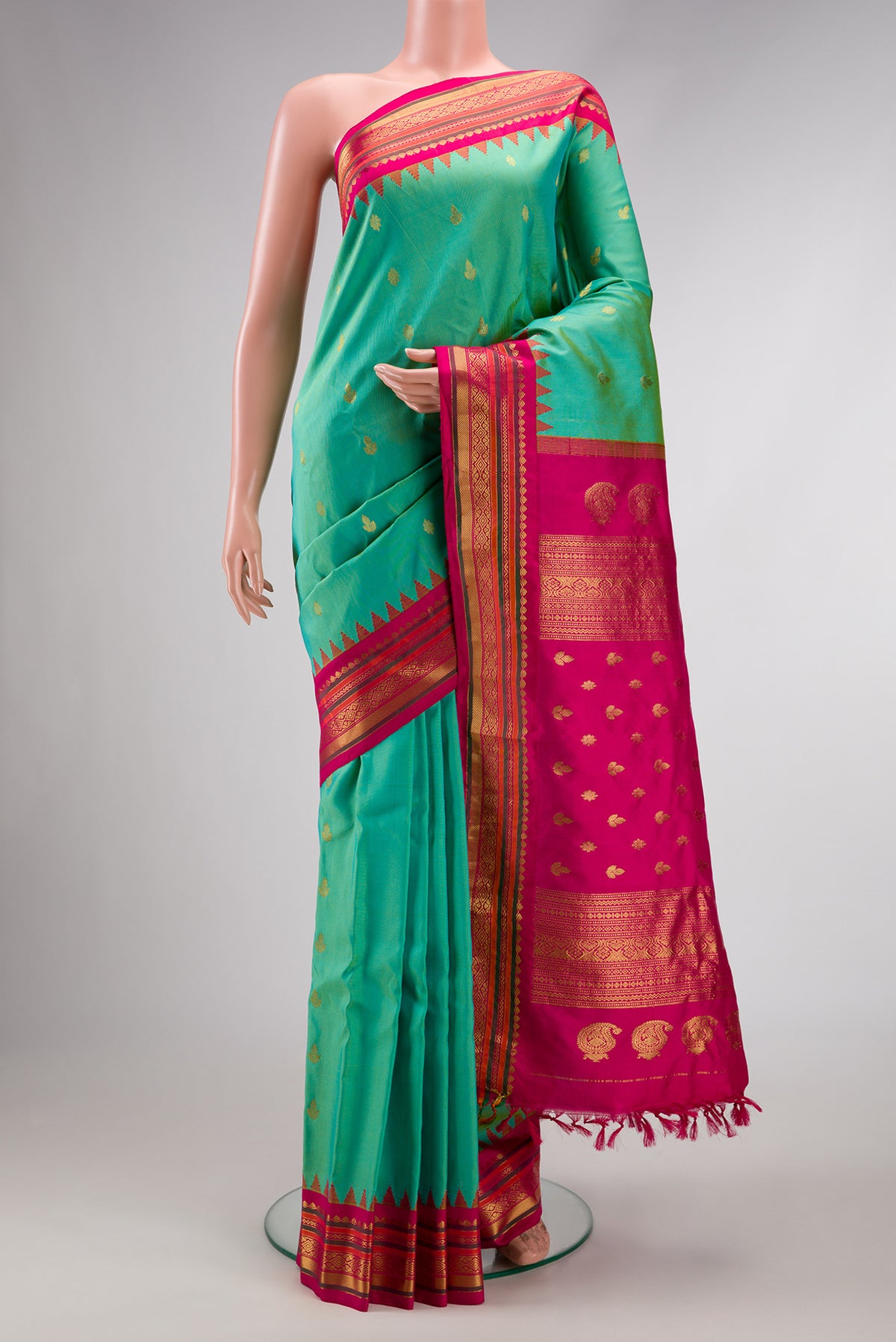 Light Green Dual Tone Gadwal Silk Saree with Zari Butta on the body and Zari Border.  displayed on a mannequin