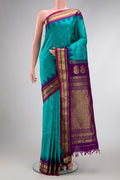 Maya Blue Dual Tone Gadwal Silk Saree with Zari Butta on the body and Zari Border.  displayed on a mannequin