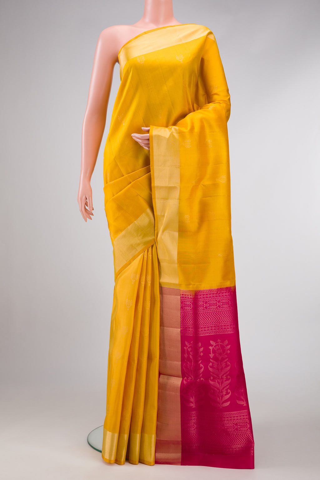 Yellow Dual Tone Soft Silk Saree with Zari Butta on the body and Zari Border.  displayed on a mannequin