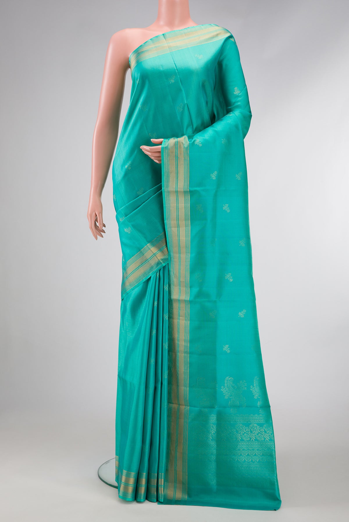 Sea Green Dual Tone Soft Silk Saree with Zari Butta on the body and Zari Border.  displayed on a mannequin