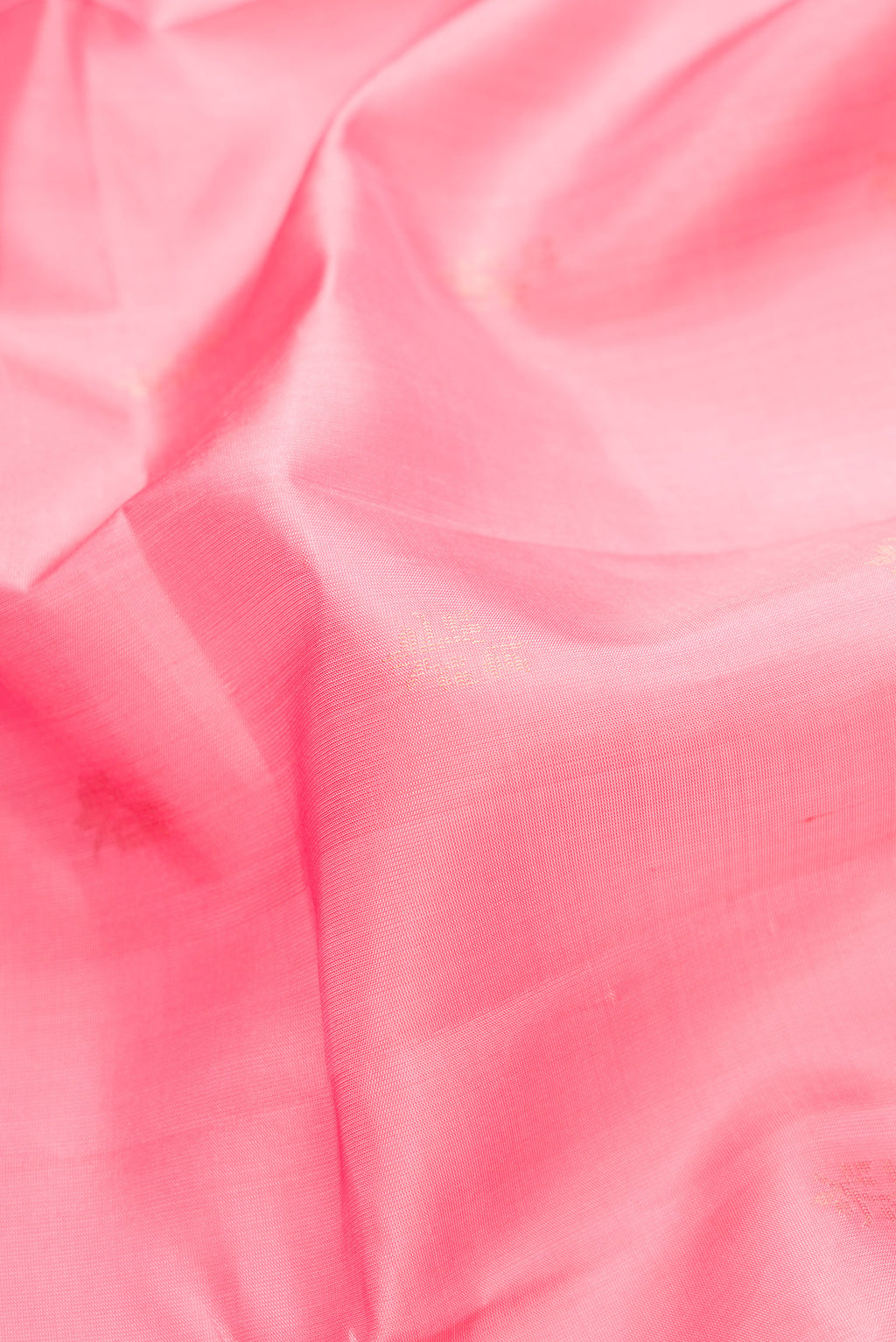 Close up of Pink Dual Tone Soft Silk Saree with Zari Butta on the body and Zari Border.  displaying folds