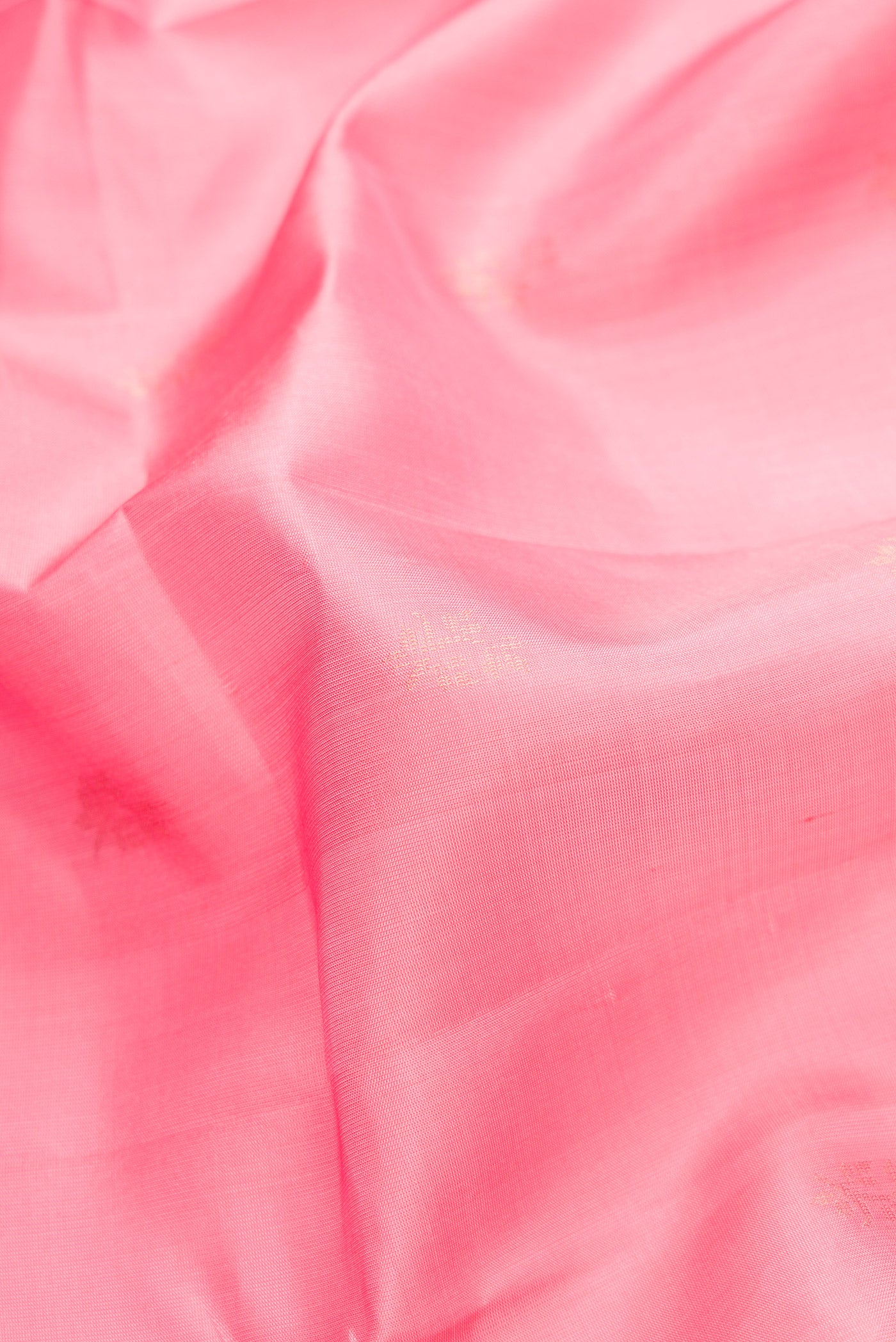 Close up of Pink Dual Tone Soft Silk Saree with Zari Butta on the body and Zari Border.  displaying folds