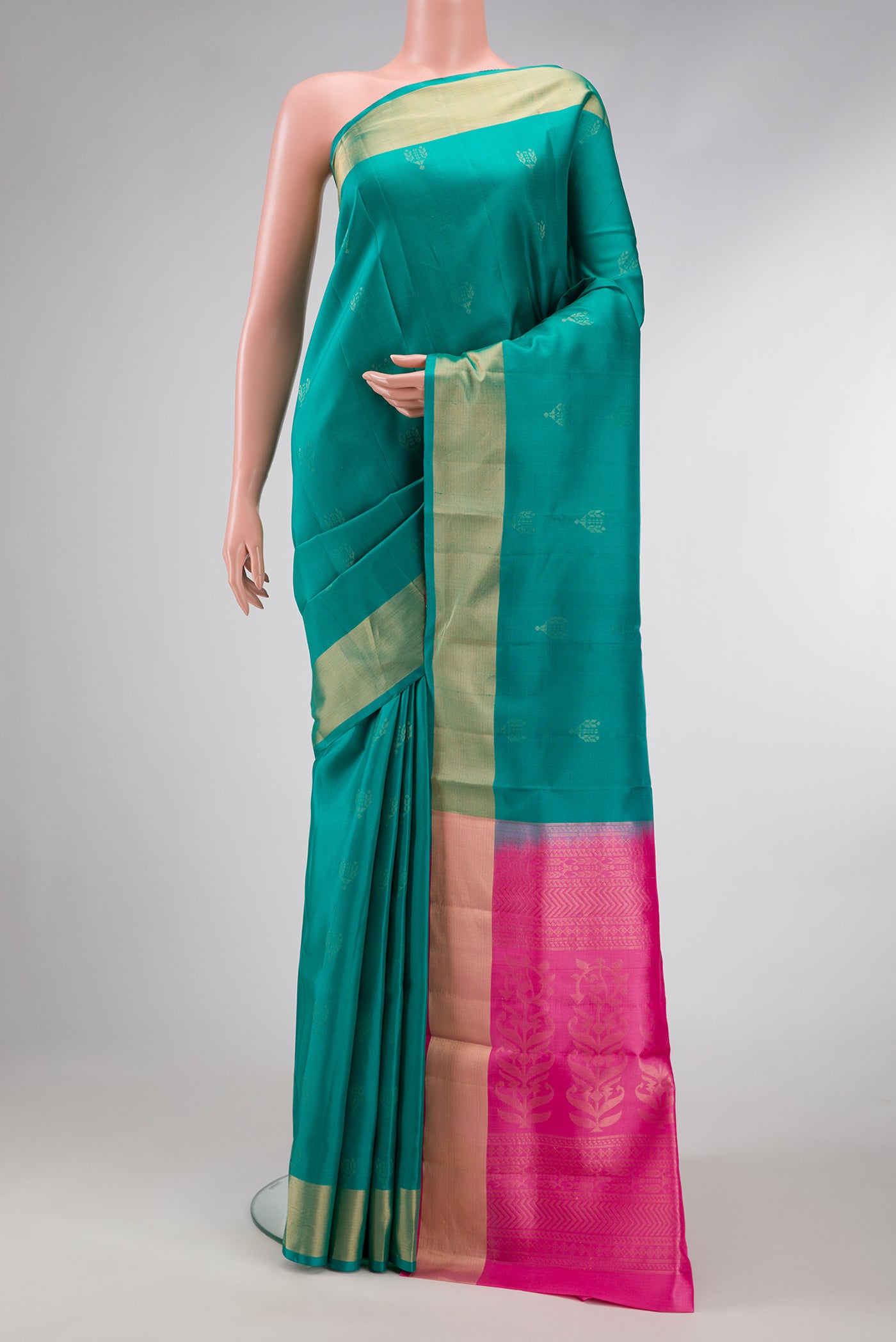 Sea Green Dual Tone Soft Silk Saree with Zari Butta on the body and Zari Border.  displayed on a mannequin
