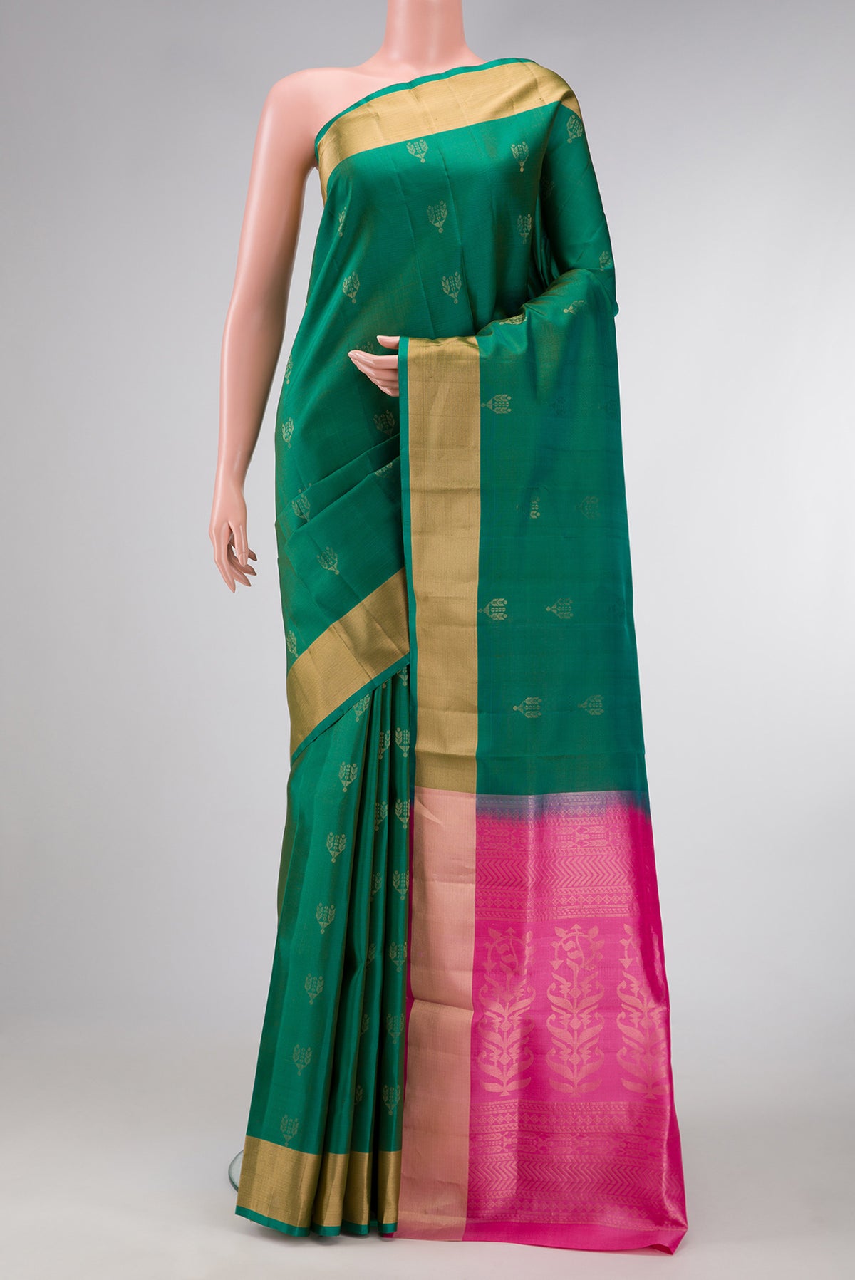 Green Dual Tone Soft Silk Saree with Zari Butta on the body and Zari Border.  displayed on a mannequin