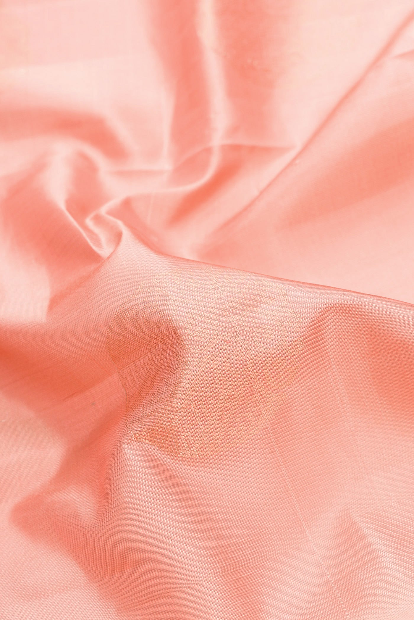 Close up of Rose Gold Dual Tone Soft Silk Saree with Zari Butta on the body and Zari Border.  displaying folds