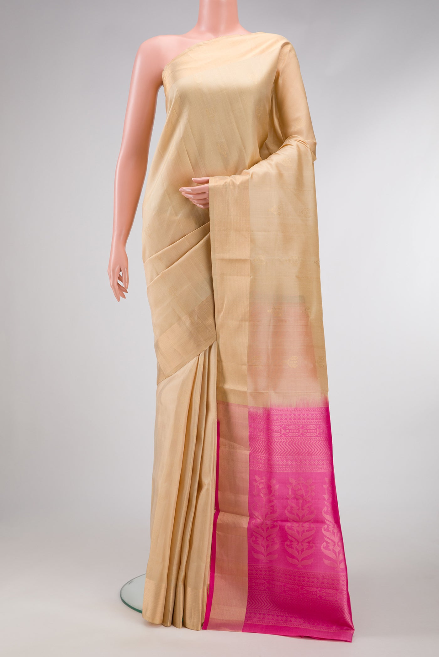 Beige Dual Tone Soft Silk Saree with Zari Butta on the body and Zari Border.  displayed on a mannequin