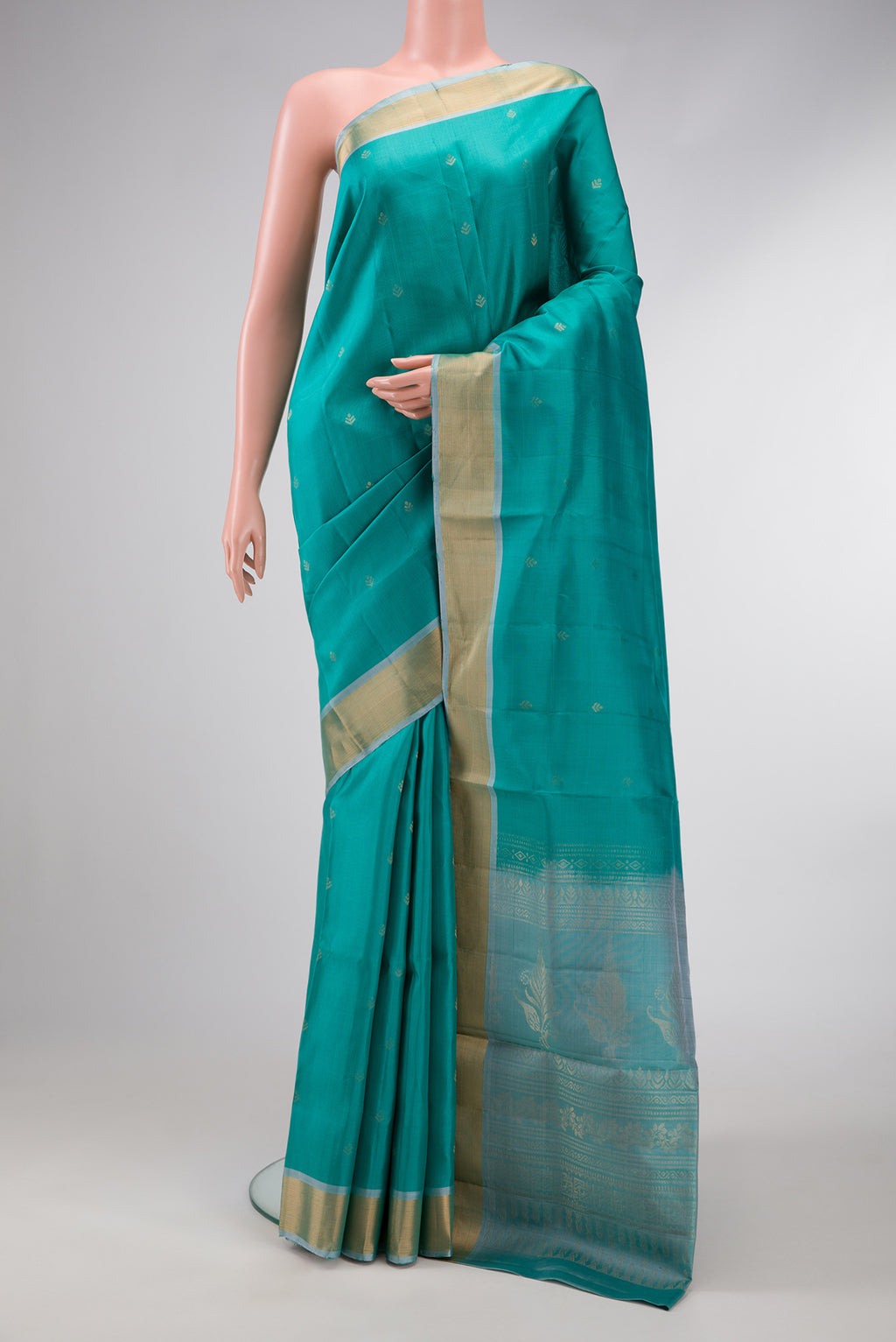Green Dual Tone Soft Silk Saree with Zari Butta on the body and Zari Border.  displayed on a mannequin