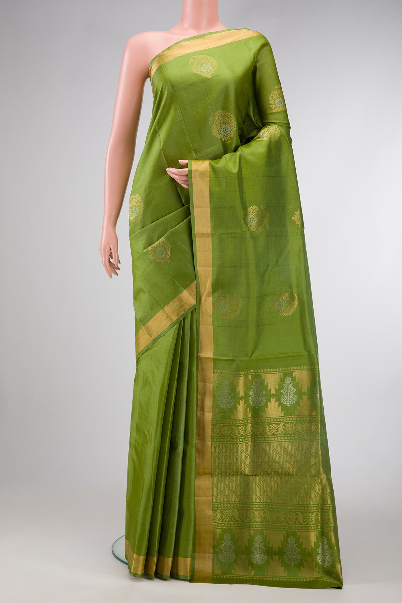Pista Green Dual Tone Soft Silk Saree with Zari Butta on the body and Zari Border.  displayed on a mannequin