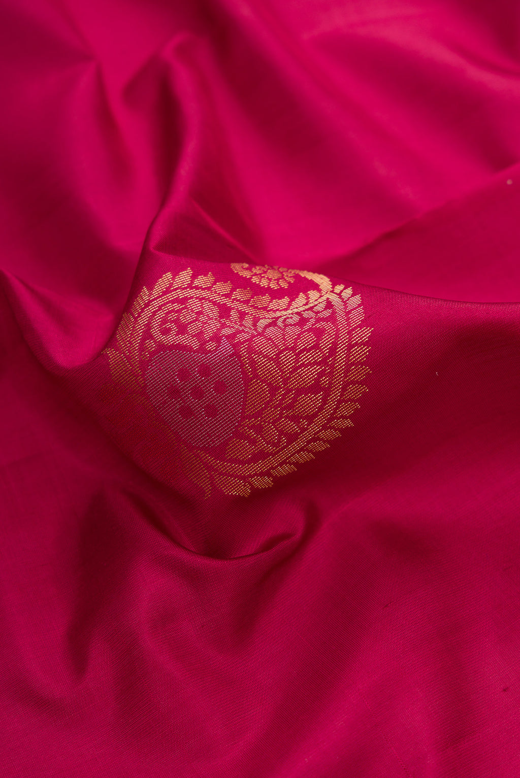 Close up of Maroon Dual Tone Soft Silk Saree with Zari Butta on the body and Zari Border.  displaying folds