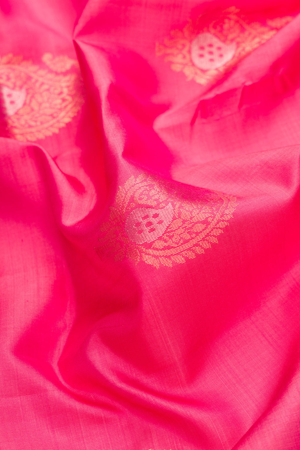 Close up of Pink Dual Tone Soft Silk Saree with Zari Butta on the body and Zari Border.  displaying folds